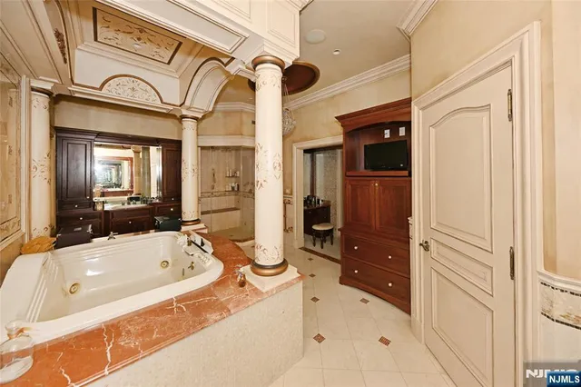 a bathroom with a bathtub shower and a sink