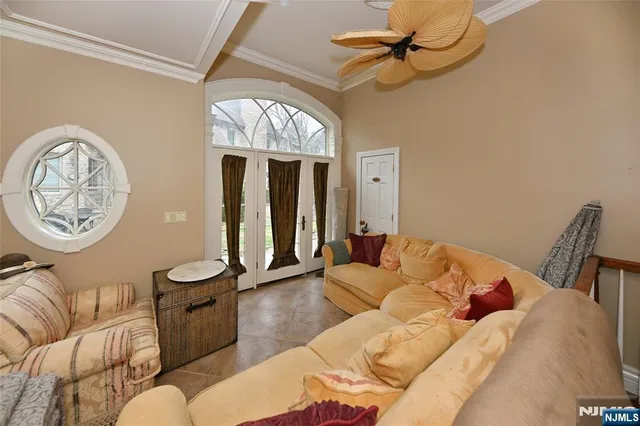 a living room with furniture a clock and a chandelier