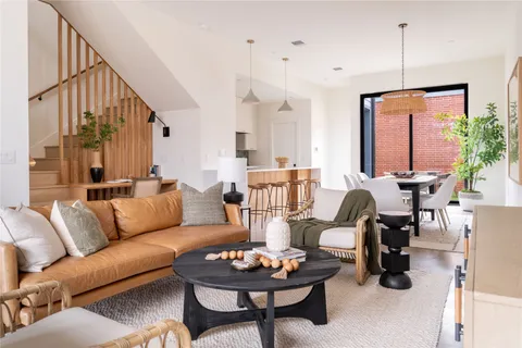 a living room with furniture and a potted plant