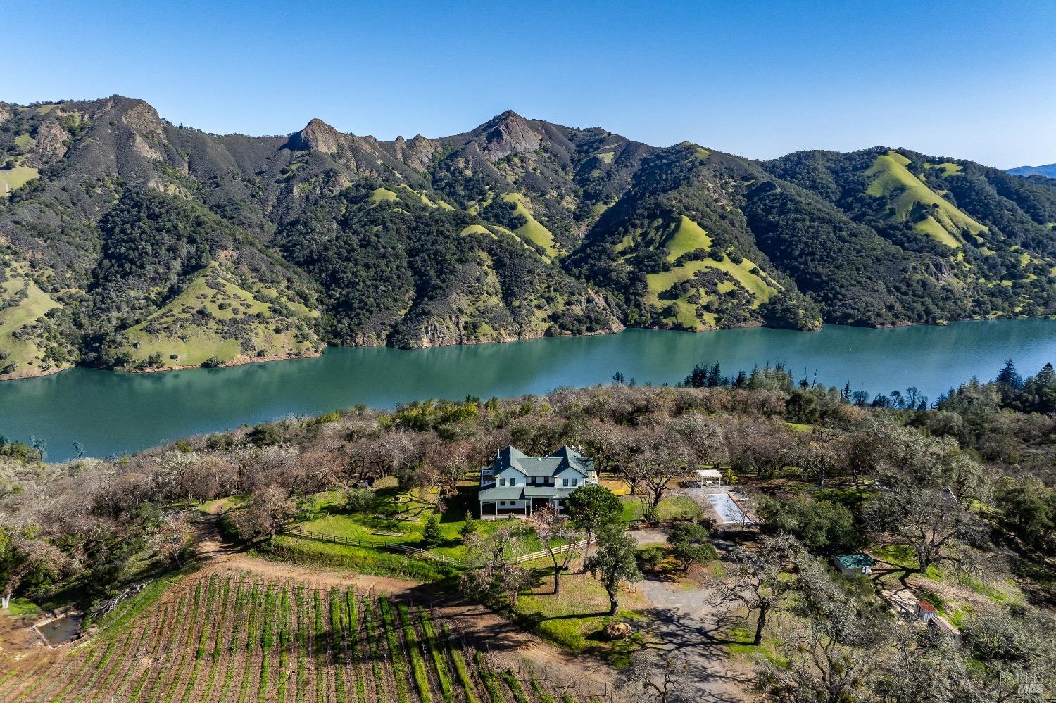 an aerial view of a house with a lake view