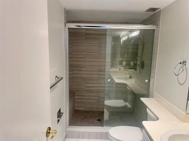 a bathroom with a toilet and a shower
