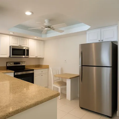 a kitchen with a refrigerator stove and microwave