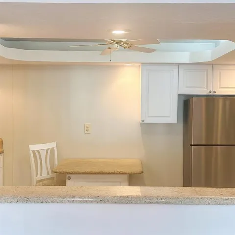 a bathroom with a refrigerator and a cabinets