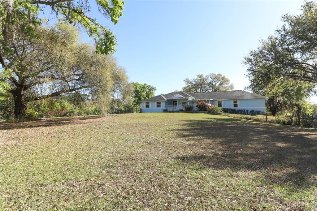 7435 Redwing Road Groveland, FL 34736 - Photo 1 of 1 a view of a field with large trees