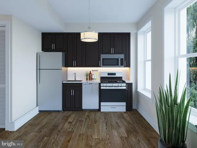 a kitchen with stainless steel appliances a refrigerator and a stove