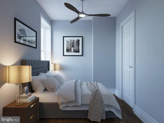 a bed room with a bed and a lamp