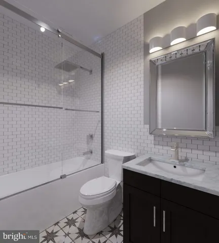 a bathroom with a bathtub shower sink mirror and toilet