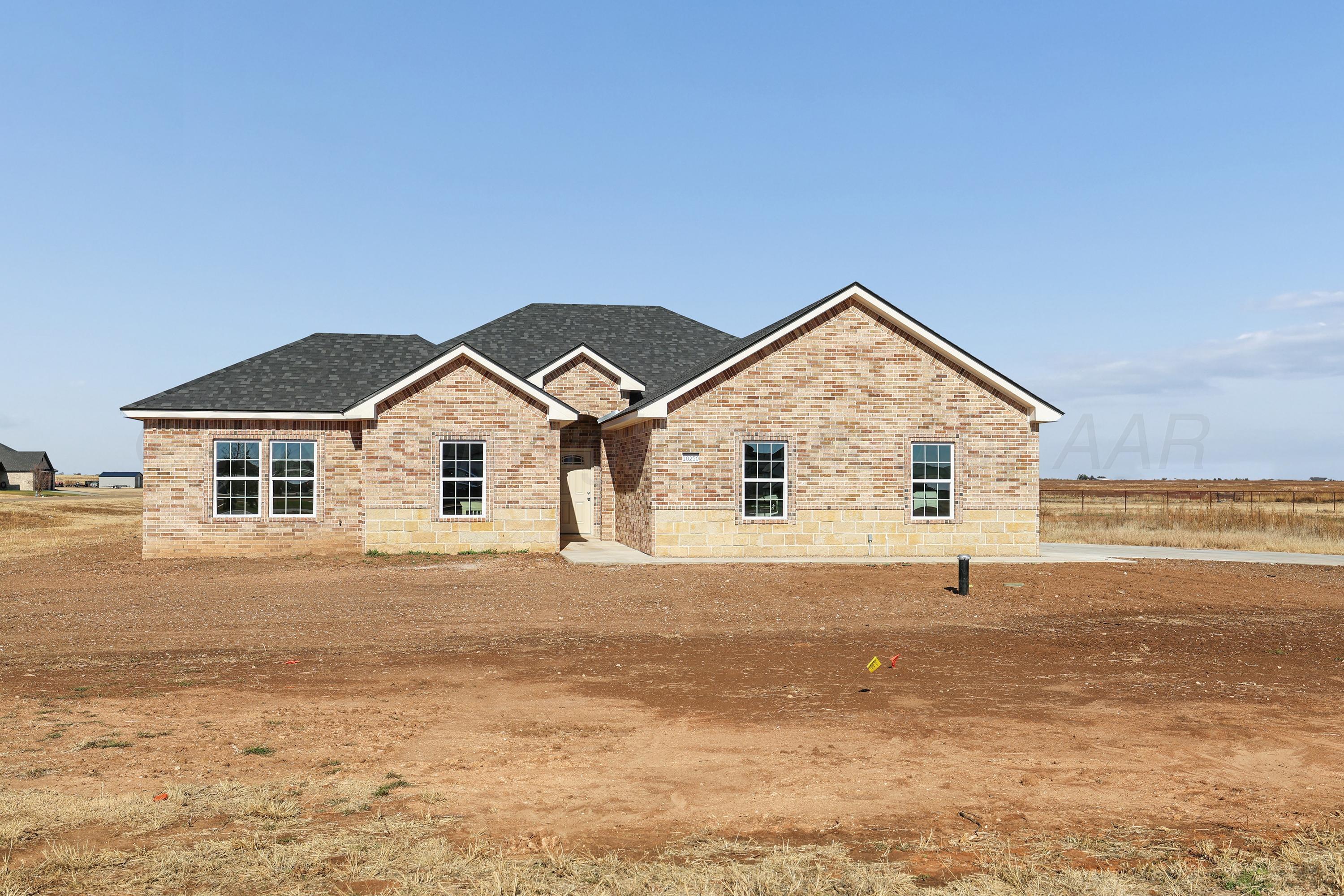 a view of house with yard and ocean view