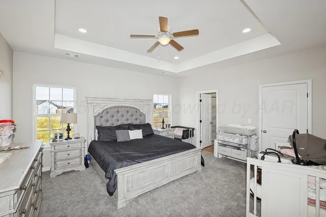 a living room with a bed furniture and a large window