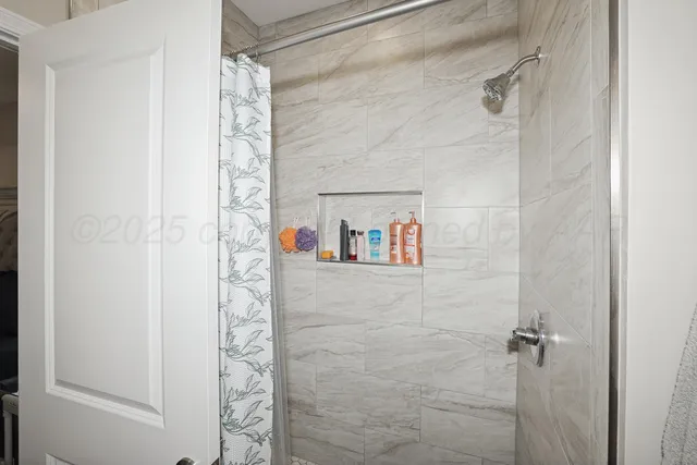 a bathroom with a shower and a shower