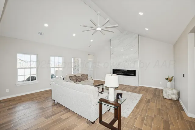 a living room with furniture and wooden floor