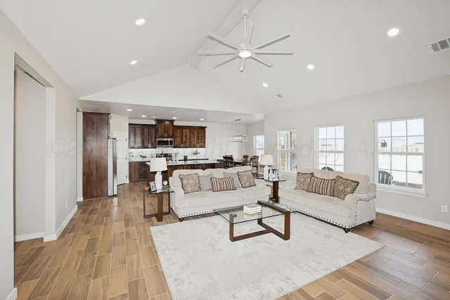 a living room with furniture and view of kitchen