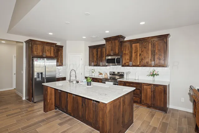 a kitchen with a sink stove and refrigerator