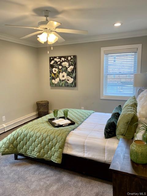 420 Terrace Road, Unit T10420 Bayport, NY 11705 - Photo 7 of 9 a bedroom with a bed and a chandelier