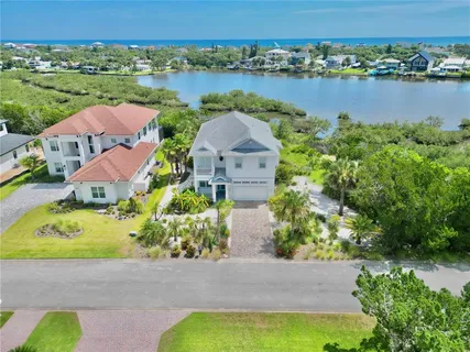 an aerial view of a house with outdoor space and lake view