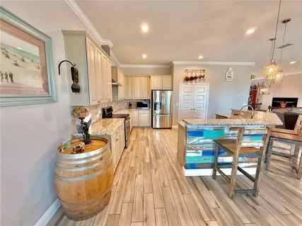 a kitchen with a refrigerator and a stove top oven