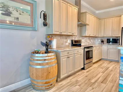 a kitchen with stainless steel appliances granite countertop a sink stove and wooden floor