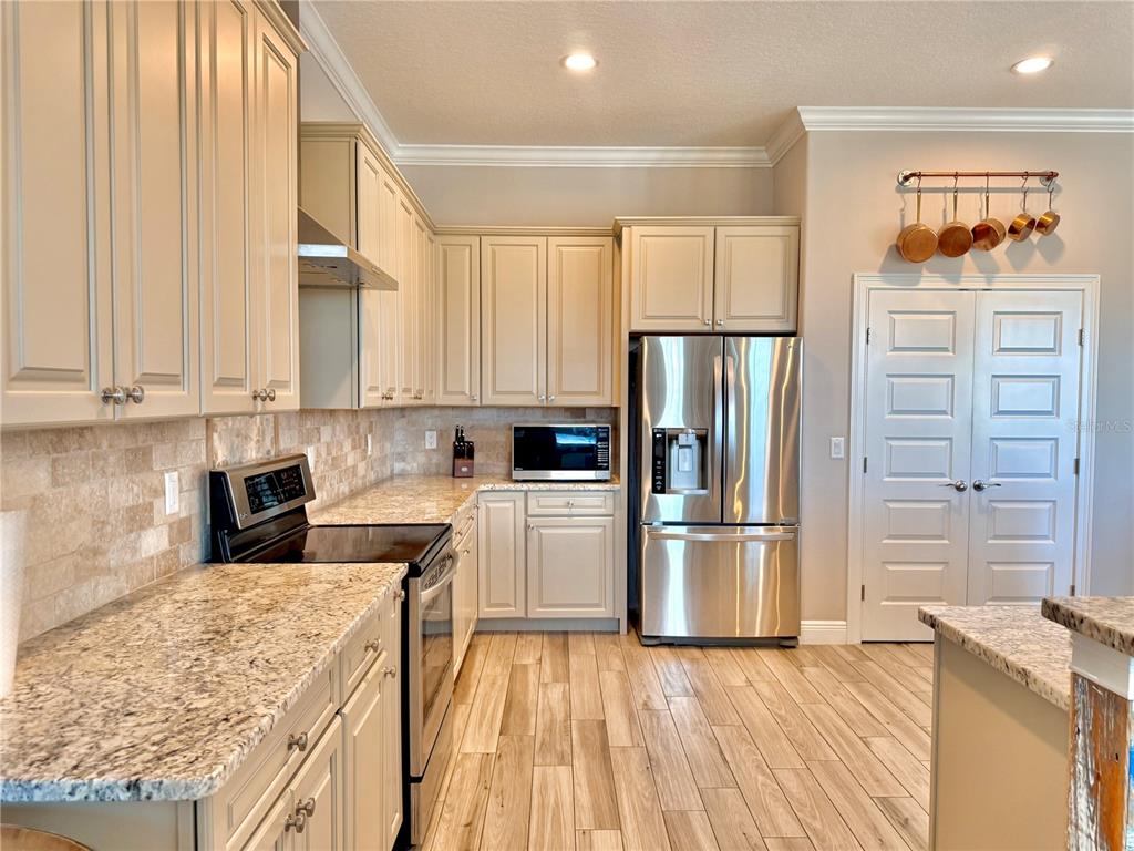 2569 Palm Avenue Flagler Beach, FL 32136 - Photo 14 of 69 a kitchen with a refrigerator and a stove top oven