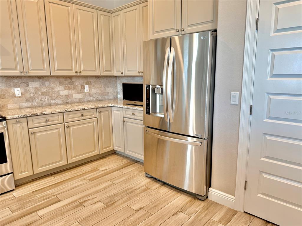 2569 Palm Avenue Flagler Beach, FL 32136 - Photo 16 of 69 a white refrigerator freezer sitting inside of a kitchen