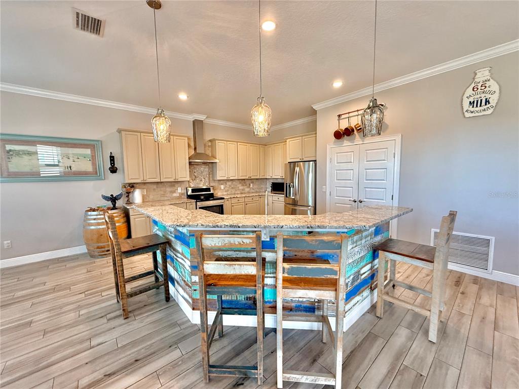 2569 Palm Avenue Flagler Beach, FL 32136 - Photo 18 of 69 a dining room with a table chairs and a kitchen view