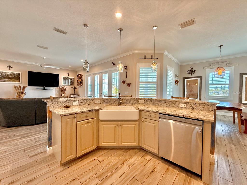 2569 Palm Avenue Flagler Beach, FL 32136 - Photo 19 of 69 a large kitchen with kitchen island granite countertop a sink and a wooden floor