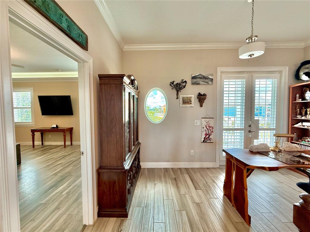 2569 Palm Avenue Flagler Beach, FL 32136 - Photo 27 of 69 a view of a hallway with wooden floor and dining room