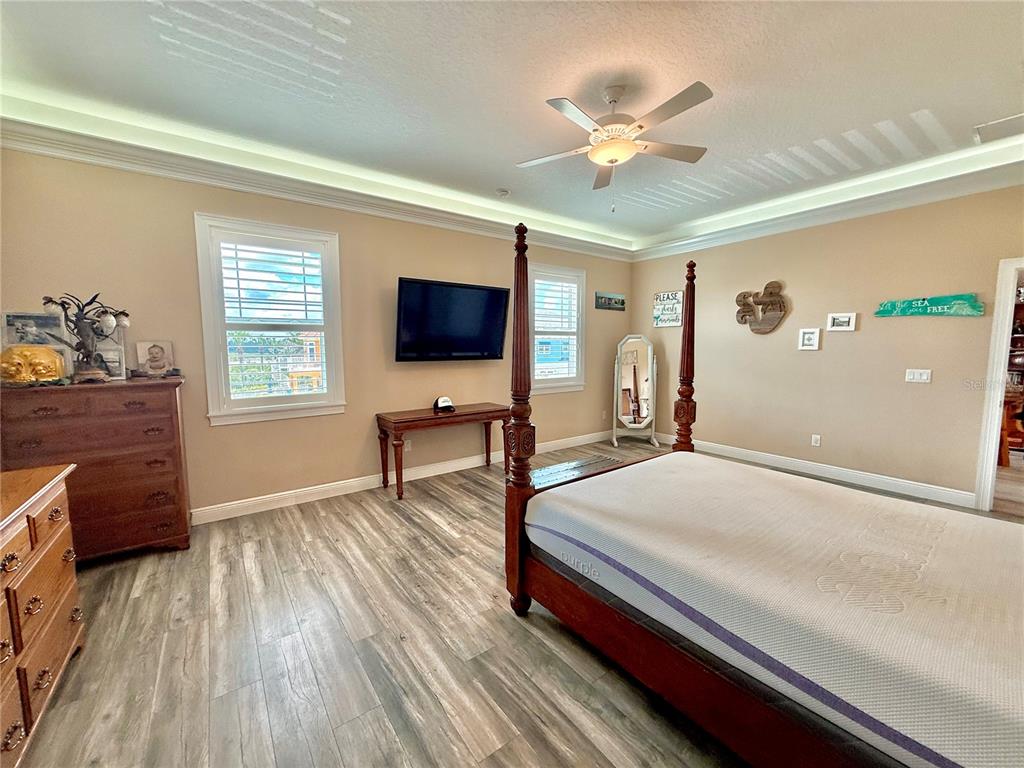 2569 Palm Avenue Flagler Beach, FL 32136 - Photo 29 of 69 a bedroom with a bed and a flat screen tv