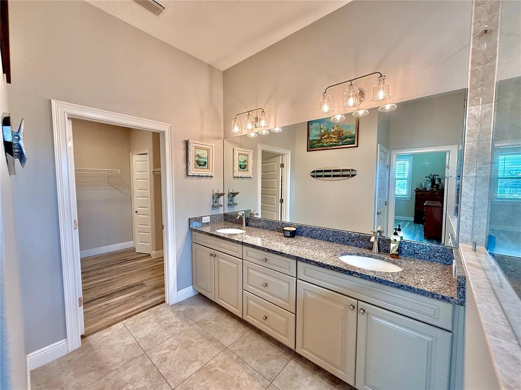 2569 Palm Avenue Flagler Beach, FL 32136 - Photo 31 of 69 a bathroom with a granite countertop sink and a mirror
