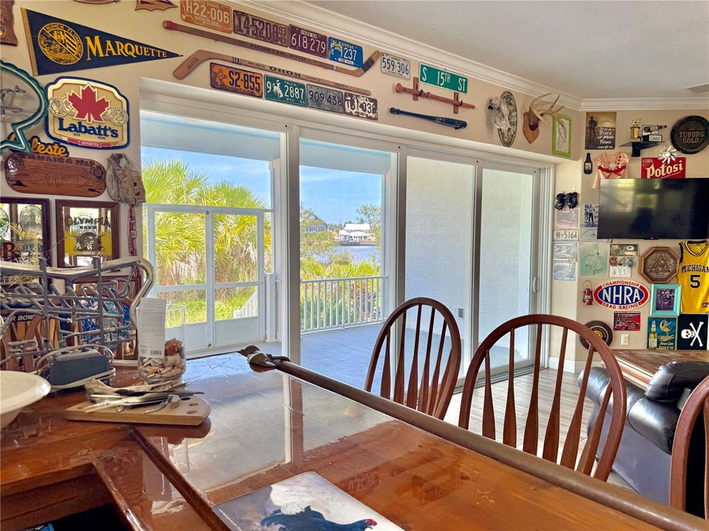 2569 Palm Avenue Flagler Beach, FL 32136 - Photo 42 of 69 a view of a dining room with furniture a chandelier and wooden floor