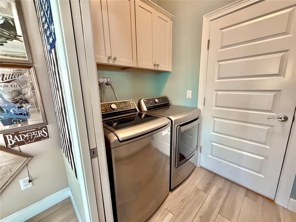2569 Palm Avenue Flagler Beach, FL 32136 - Photo 45 of 69 a utility room with wooden floor washer and dryer