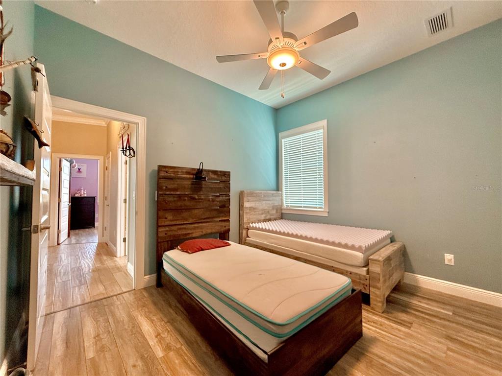 2569 Palm Avenue Flagler Beach, FL 32136 - Photo 48 of 69 a bedroom with a bed and a chandelier