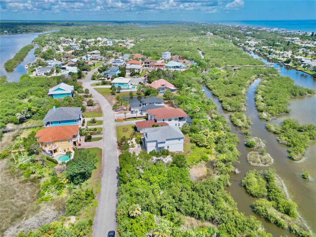 2569 Palm Avenue Flagler Beach, FL 32136 - Photo 68 of 69 an aerial view of residential houses with outdoor space and trees
