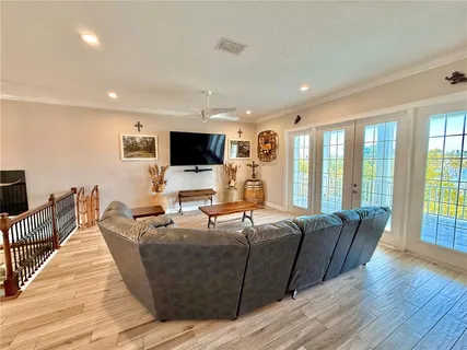 a view of a dining room with furniture wooden floor and chandelier