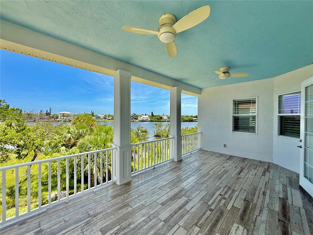 2569 Palm Avenue Flagler Beach, FL 32136 - Photo 9 of 69 a view of a room with wooden floor and iron stairs