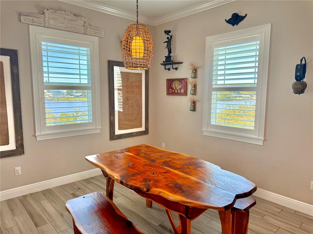 2569 Palm Avenue Flagler Beach, FL 32136 - Photo 10 of 69 a view of a dining room with furniture wooden floor and chandelier