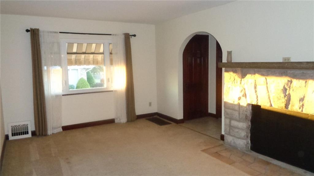 79 Beaver Grade Road McKees Rocks, PA 15136 - Photo 3 of 20 Living Room, with Stone Fireplace and Large Picture Window. Harwood Floors throughout.