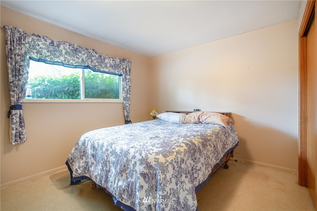 495 West Badger Road Lynden, WA 98264 - Photo 13 of 28 a bed sitting in a bedroom next to a window
