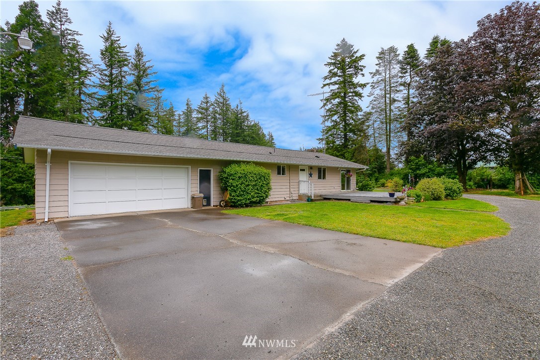 495 West Badger Road Lynden, WA 98264 - Photo 23 of 28 a view of a house with a yard and large tree