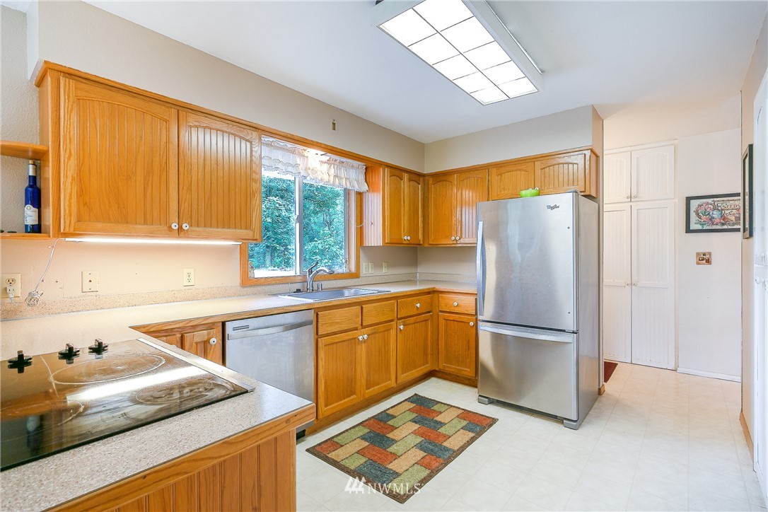 495 West Badger Road Lynden, WA 98264 - Photo 7 of 28 a kitchen with a sink appliances and cabinets