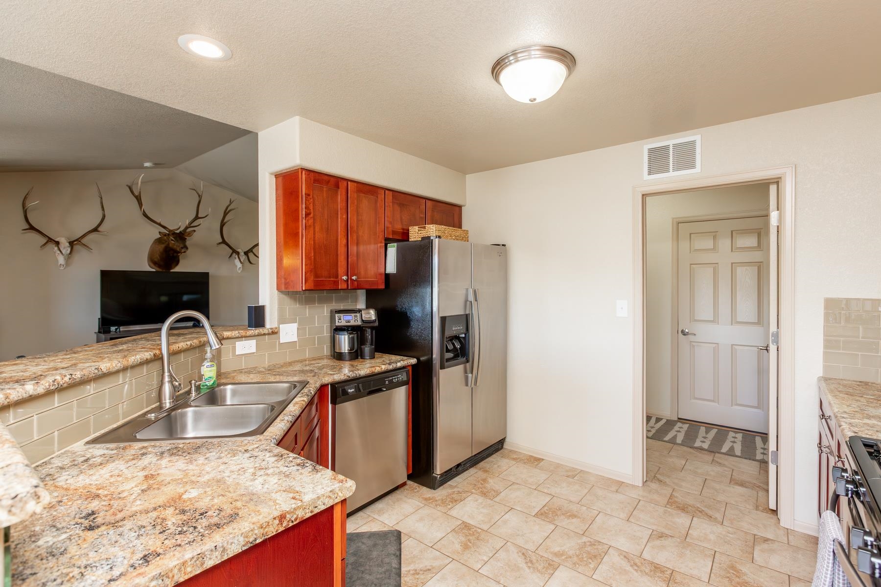 103 Red Rocks Street Fruita, CO 81521 - Photo 26 of 39 a kitchen with stainless steel appliances granite countertop a sink stove and refrigerator