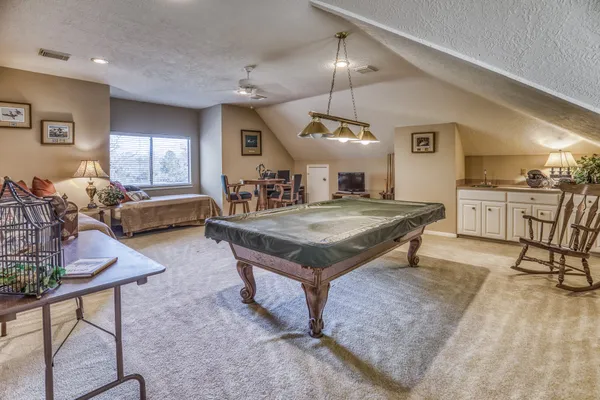 a kitchen with a stove a counter space dining table and chairs