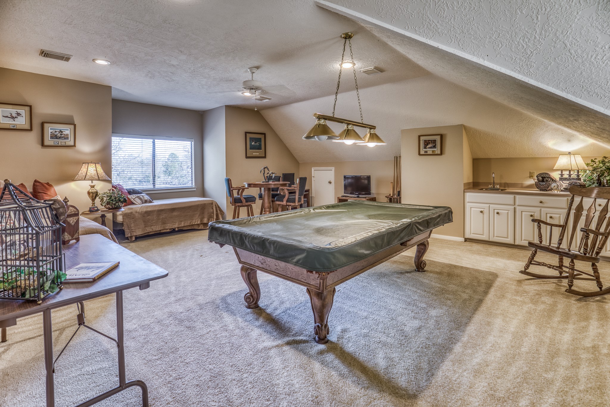 23032 Oak Road New Ulm, TX 78950 - Photo 17 of 44 a kitchen with a stove a counter space dining table and chairs