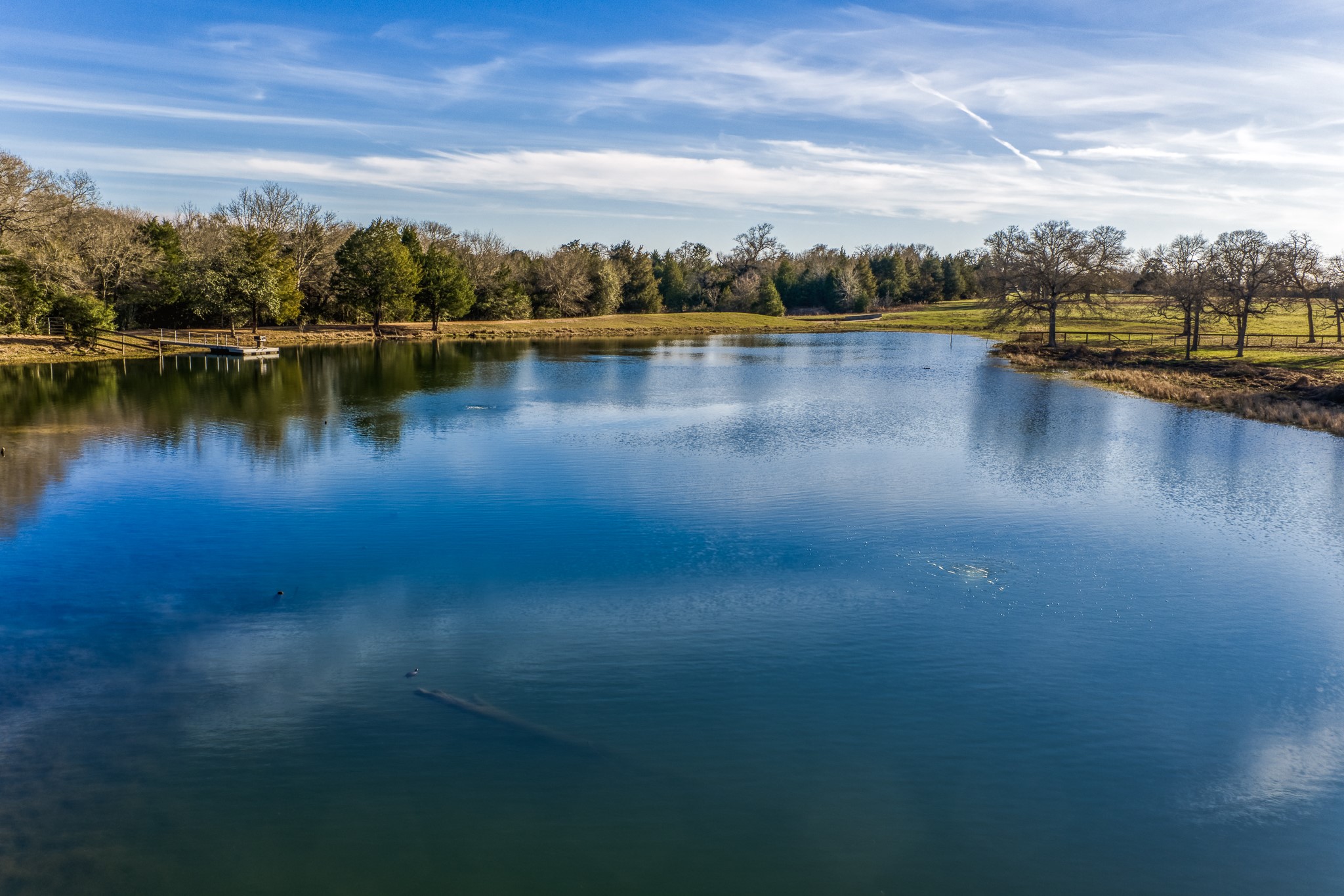 23032 Oak Road New Ulm, TX 78950 - Photo 22 of 44 a view of a lake with houses in the back