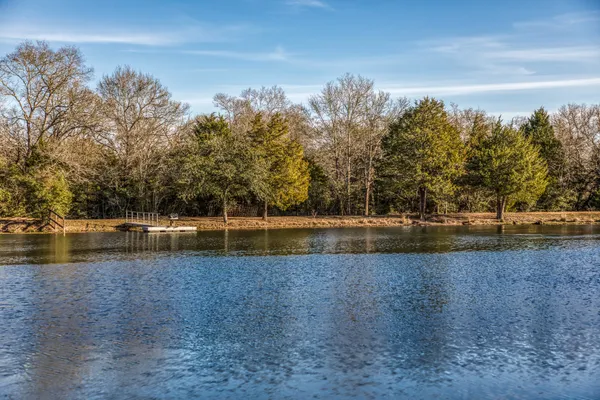 a view of a lake with houses in the back