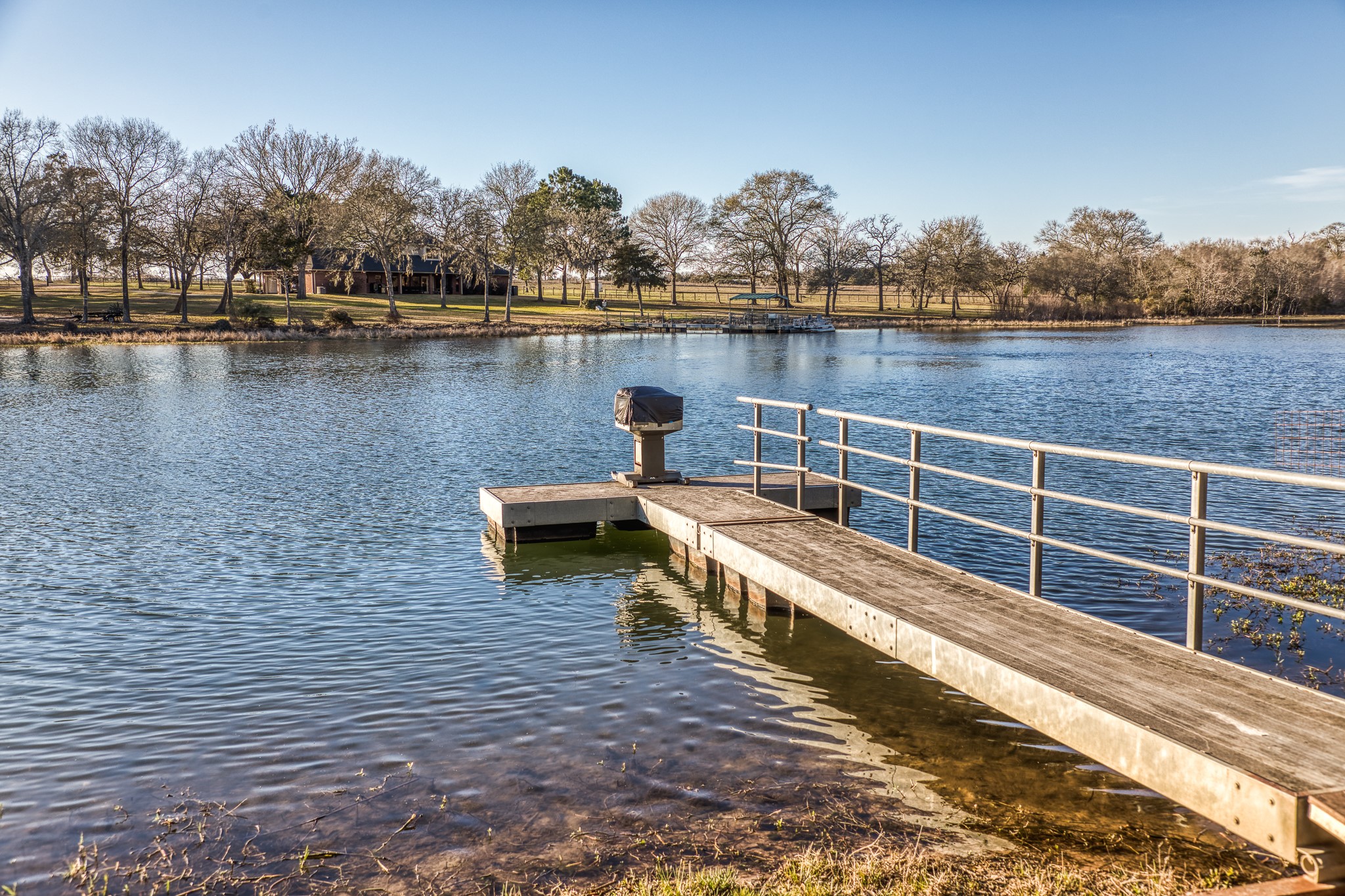 23032 Oak Road New Ulm, TX 78950 - Photo 24 of 44 a view of a lake with houses in the back