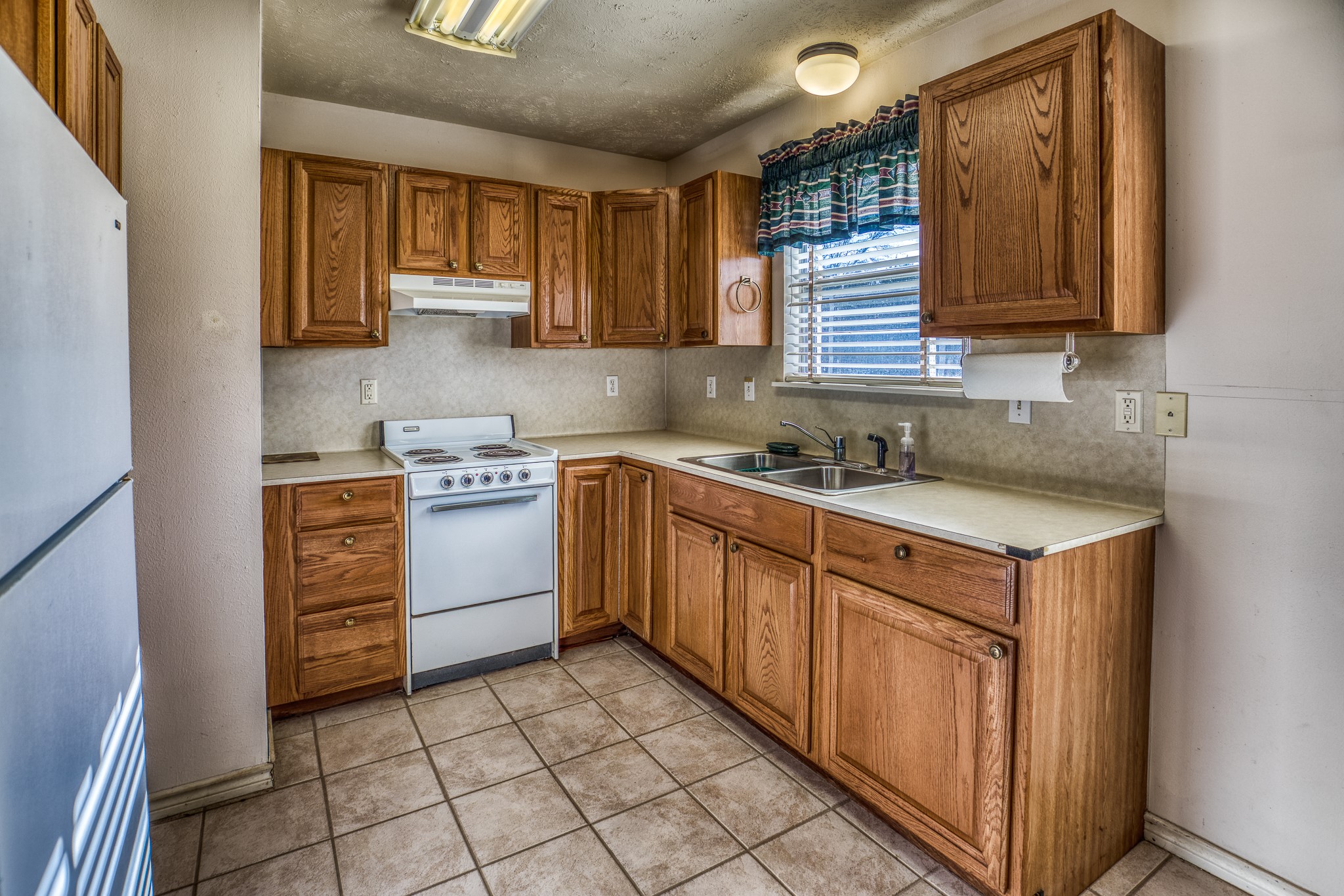 23032 Oak Road New Ulm, TX 78950 - Photo 36 of 44 a kitchen with a sink cabinets and window