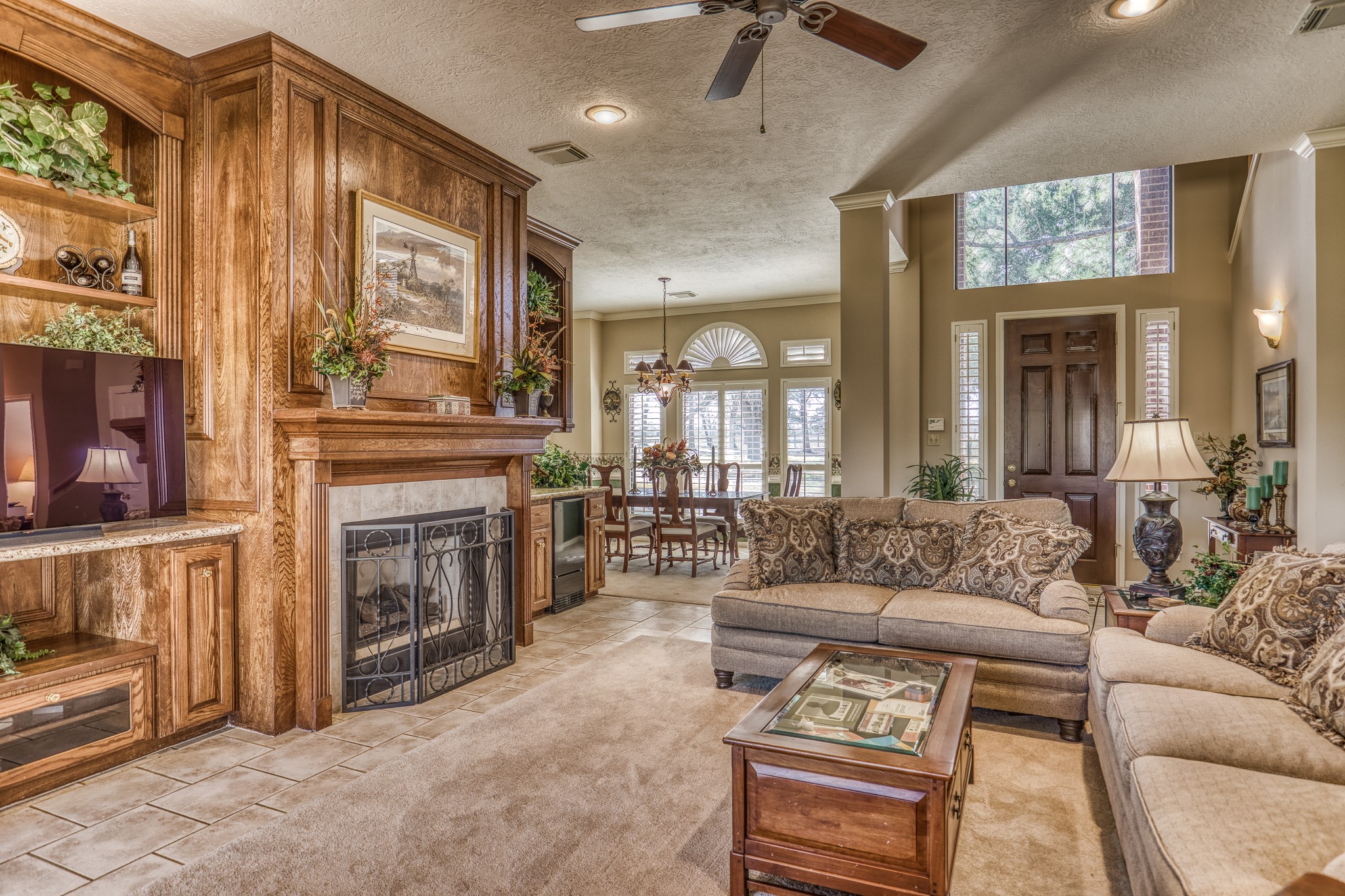 23032 Oak Road New Ulm, TX 78950 - Photo 8 of 44 a living room with furniture a fireplace and a chandelier