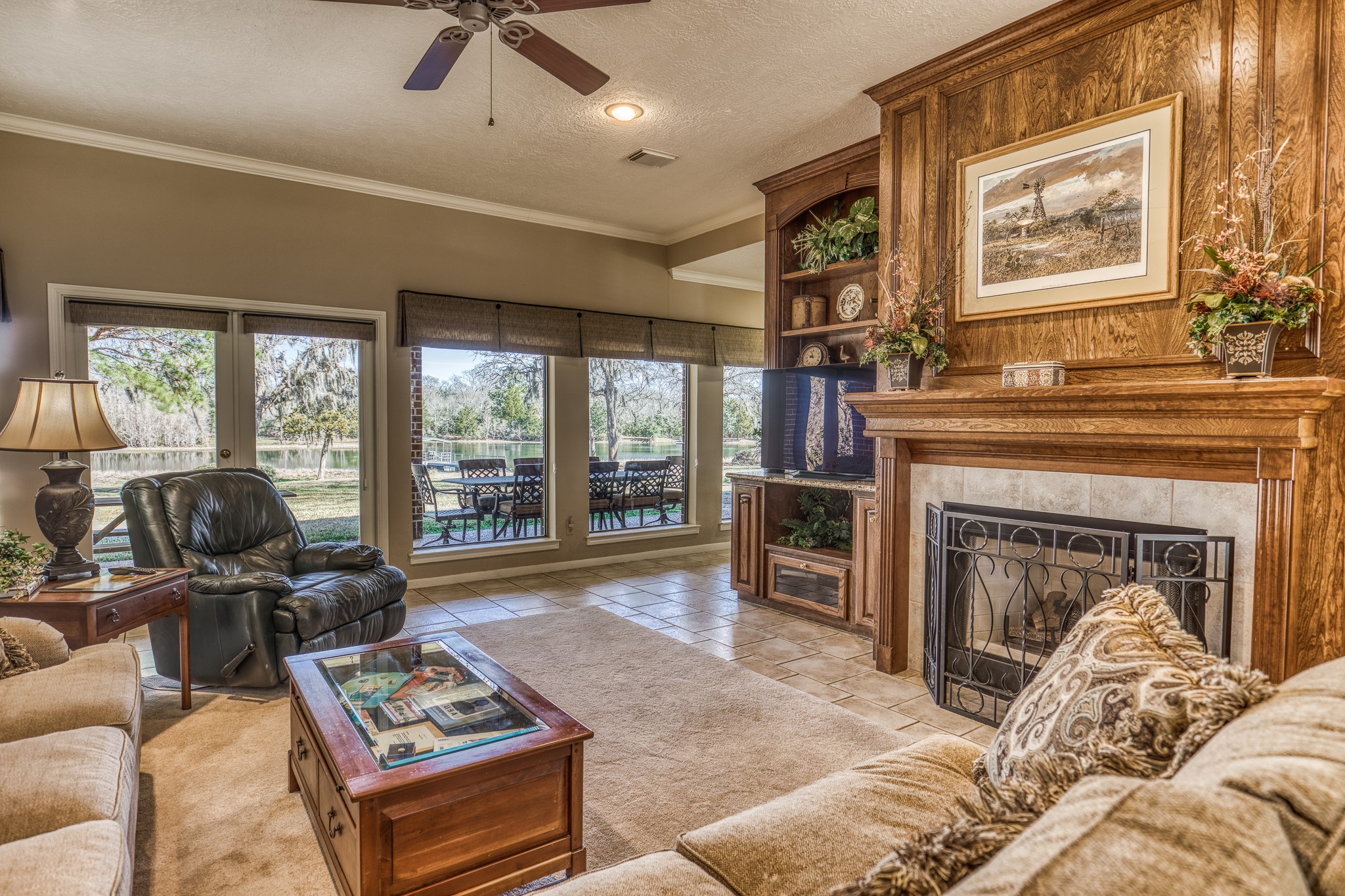 23032 Oak Road New Ulm, TX 78950 - Photo 9 of 44 a living room with furniture a fireplace and large windows
