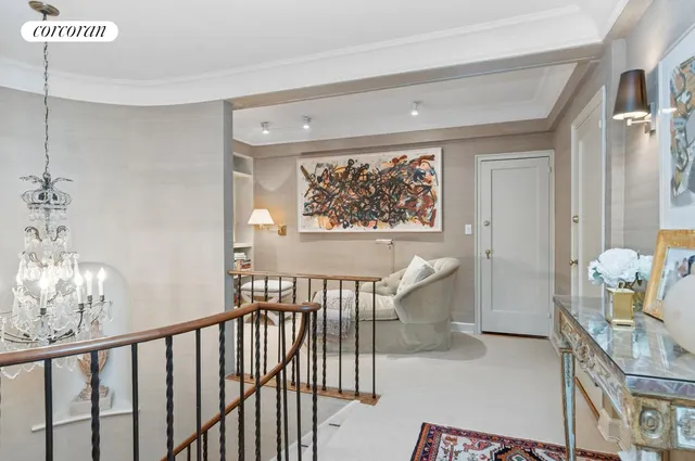 a view of a hallway with seating area and furniture