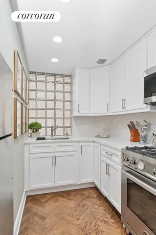 a bathroom with a sink a toilet a mirror and shower